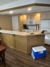 Kitchen area with a washer and dryer in the closet.