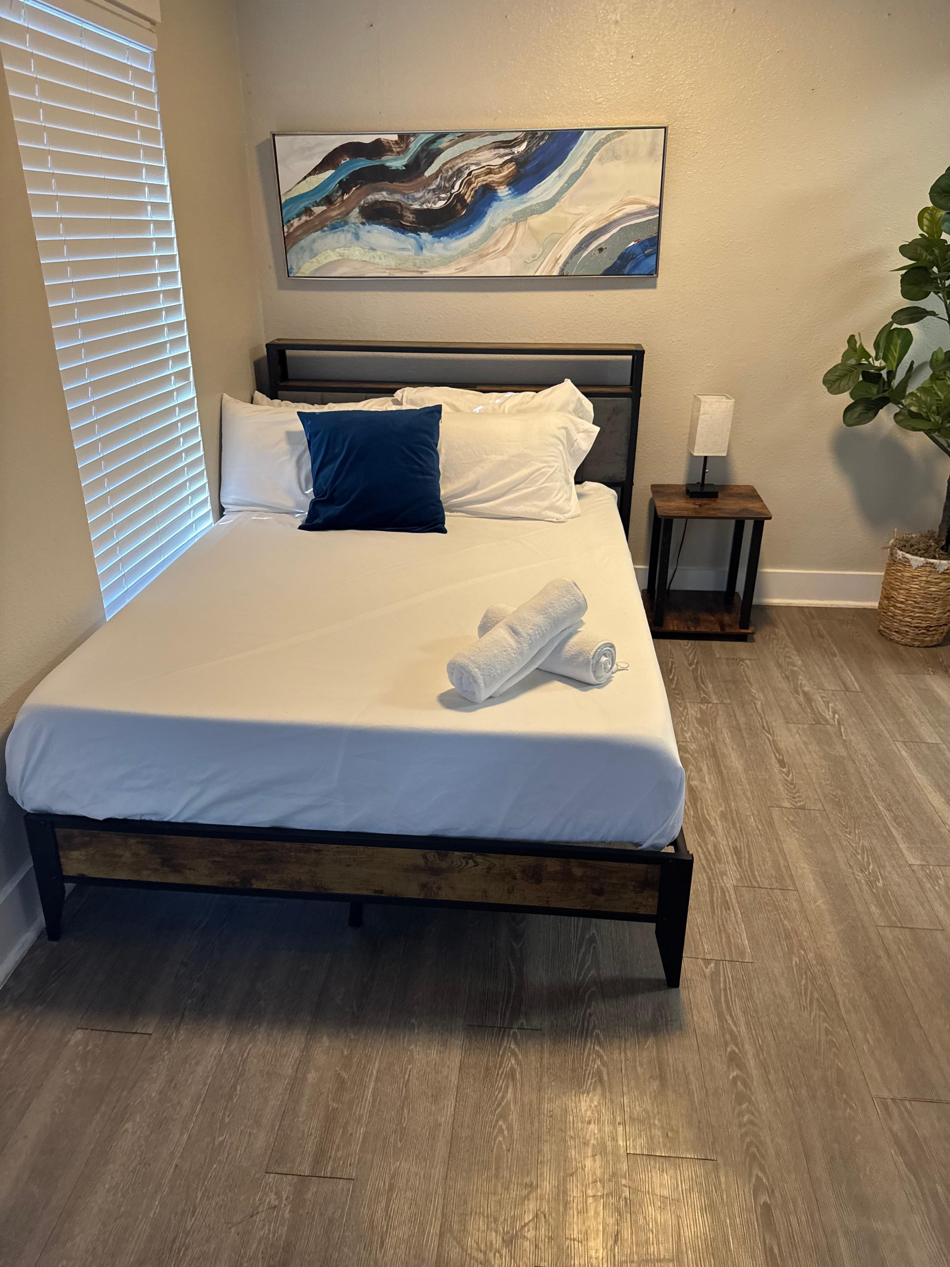 One of the beds with just sheets