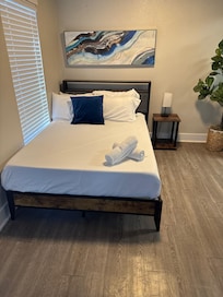 One of the beds with just sheets