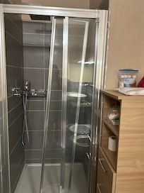 Broken shower door in the master bathroom