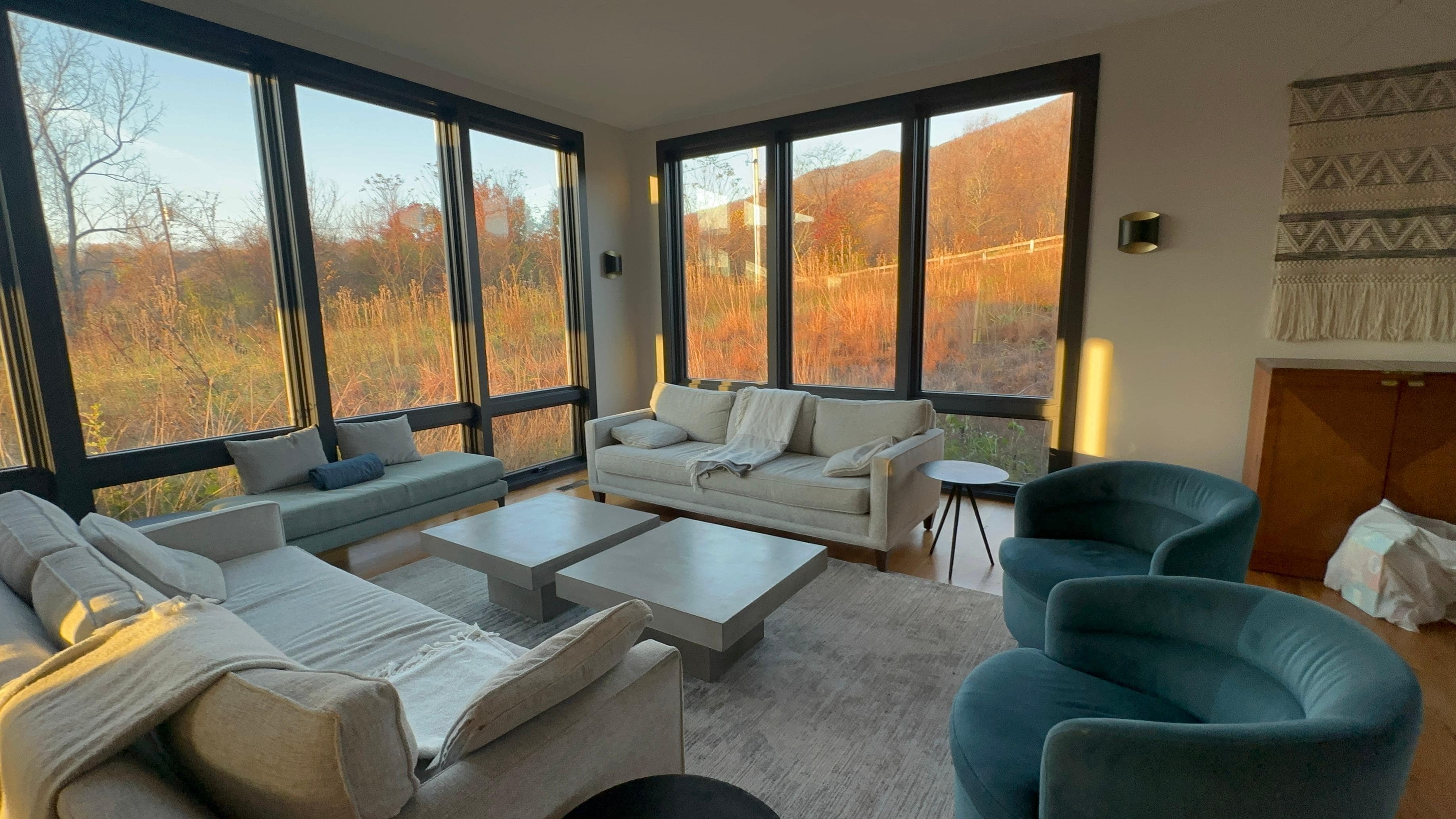 Floor to ceiling windows in family room with amazing view of fall color