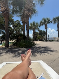 Pool side relaxing with view of beach and Gulf