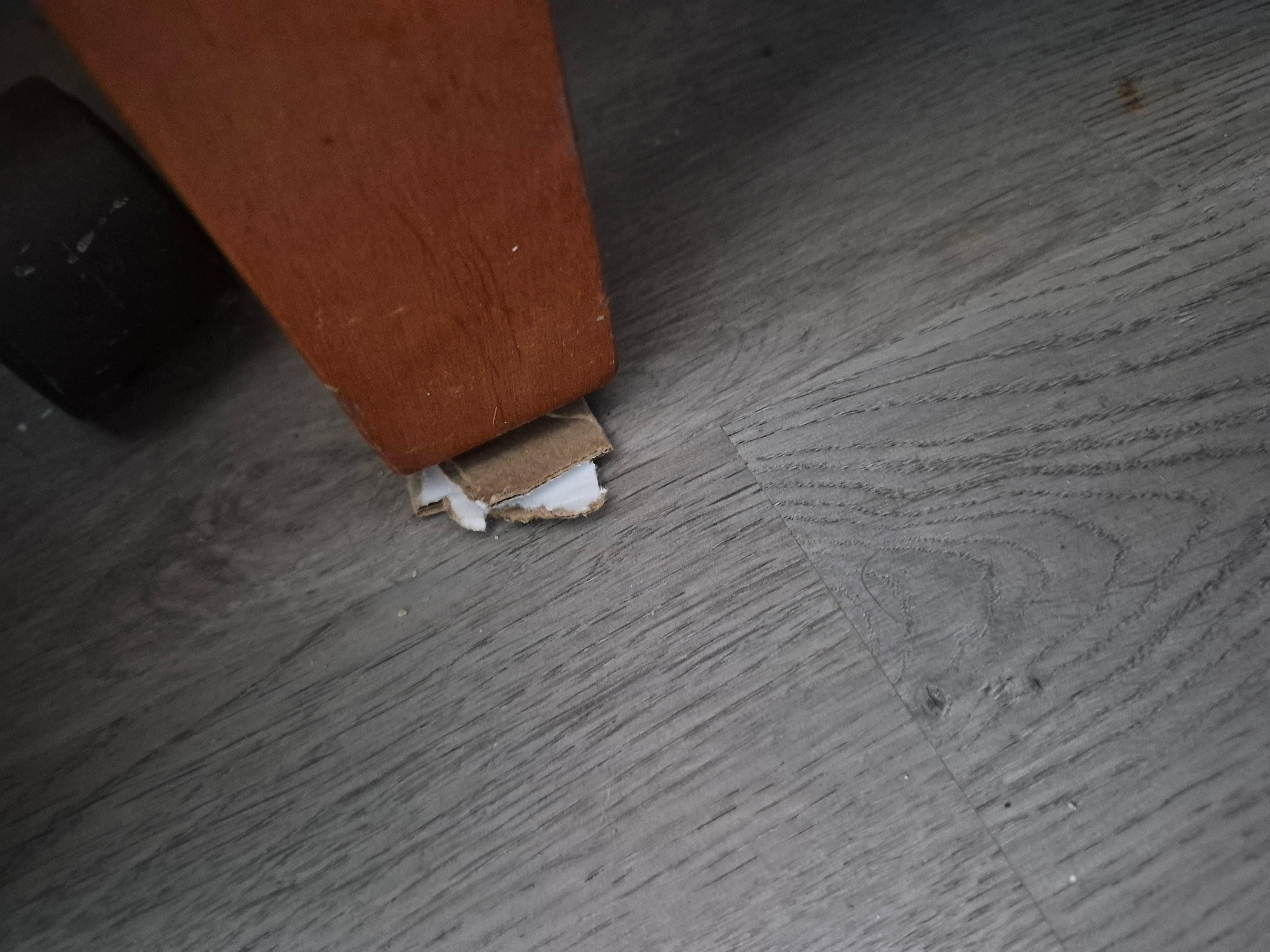 Cardboard under dresser leg.