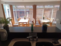 Dining room seen from the kitchen. Outdoor nook in the background.