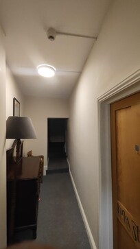 hallway, door to King Studio on the right. Access through a side entrance, relatively steep staircase, probably typical for this kind of building.