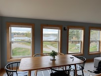 Warm, bright eating area with a view of the harbor.