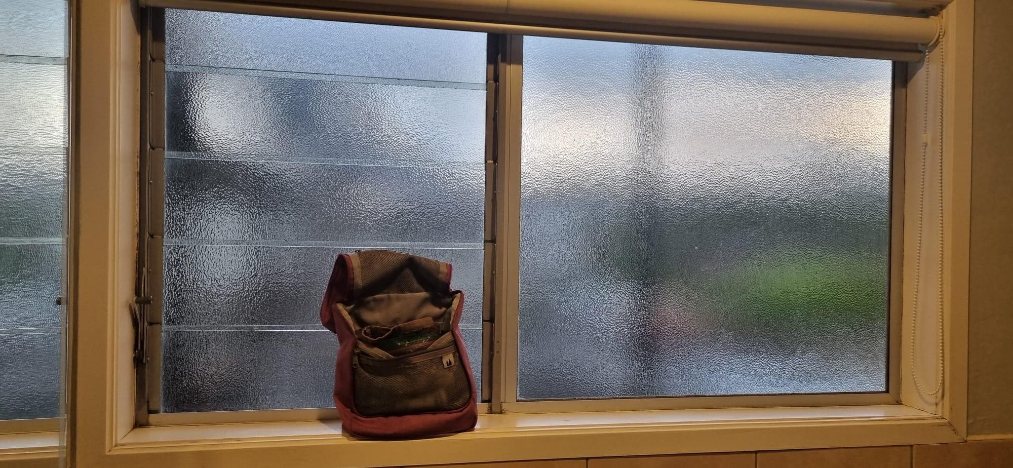 Bathroom obscure window looking onto outside corridor 
