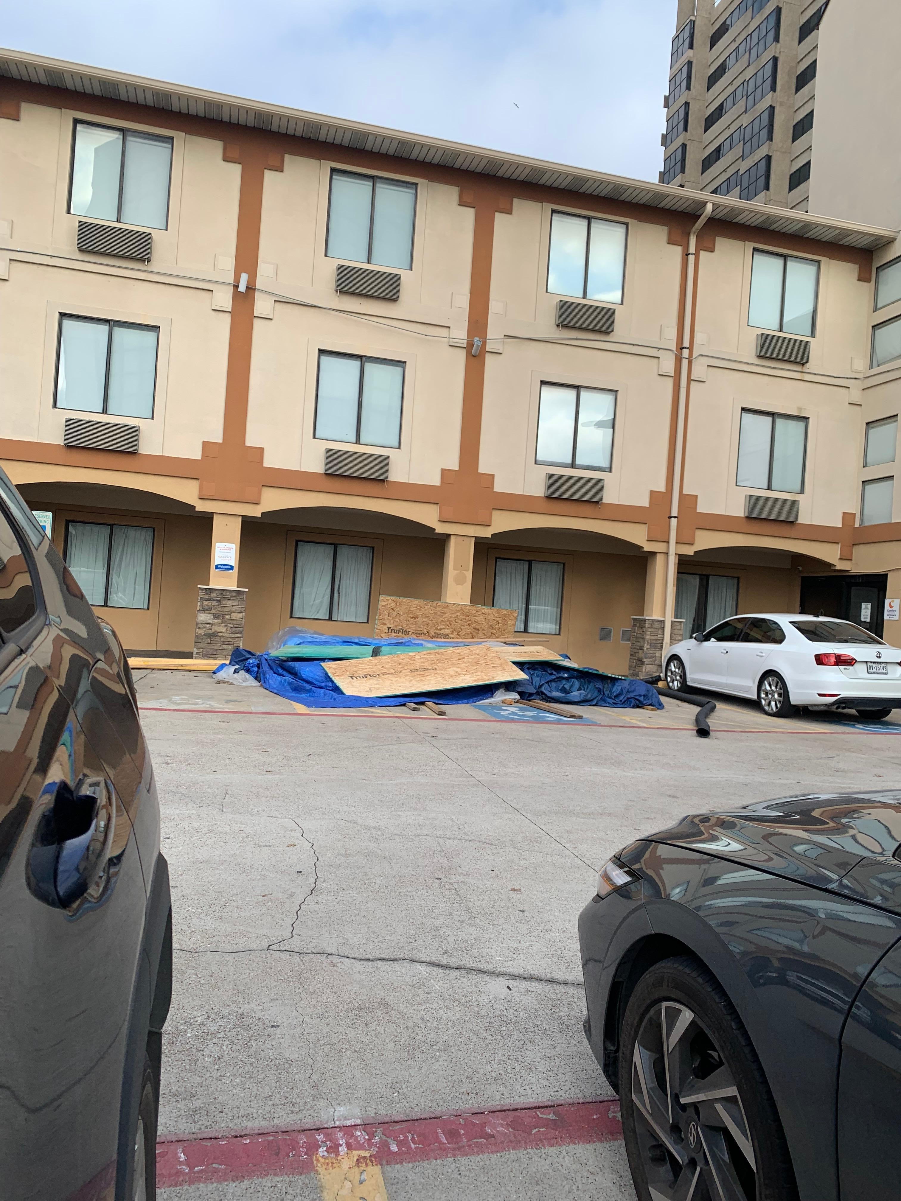 Piles of trash, carpet, dust at the entrance