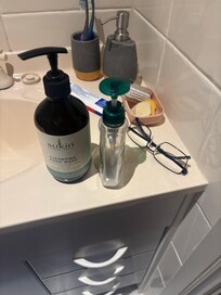 Empty hand wash and used soap in upstairs vanity.