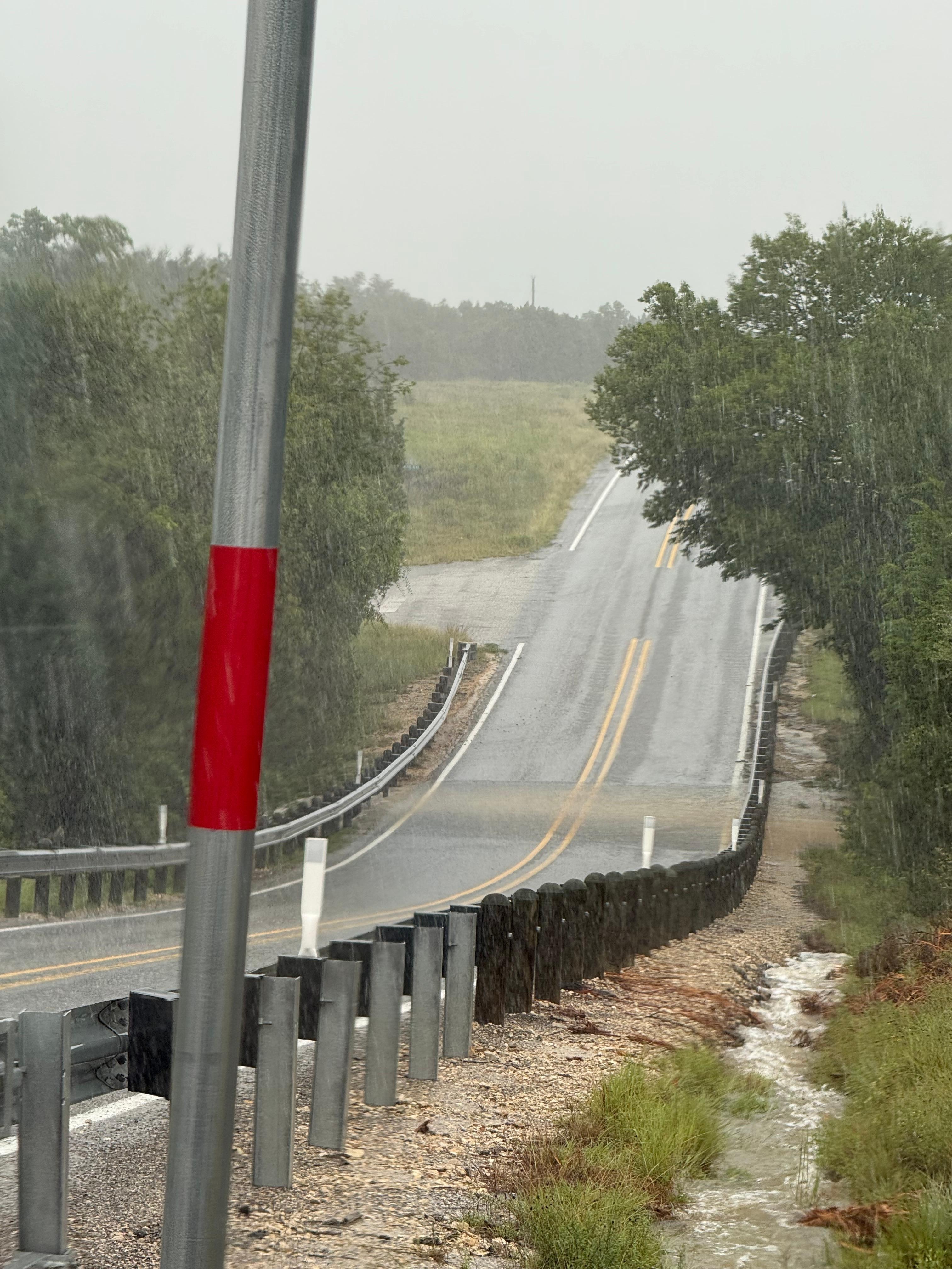 Road to west toward lake showing water across road This road is half a block from house. 