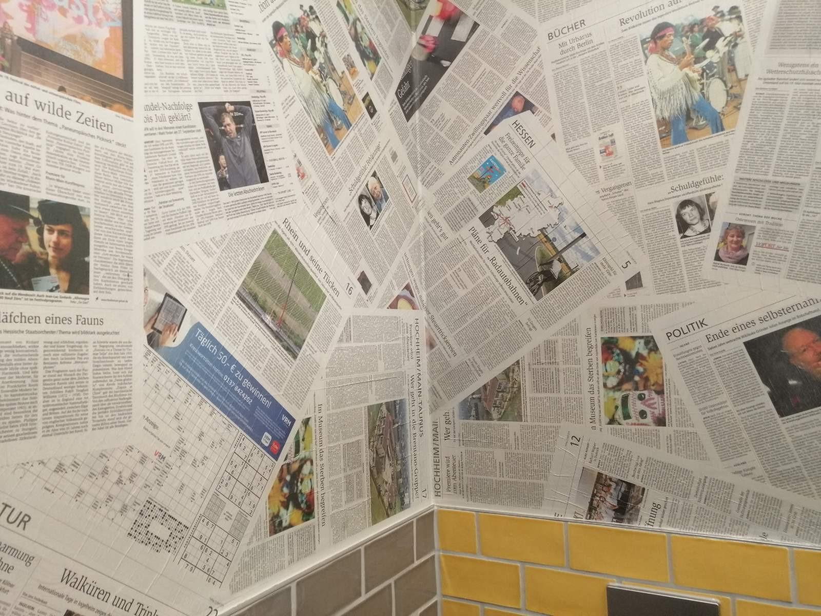 Newspaper wallpaper in bathroom looks cheap.