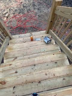 Stairway leading to the apartment, full of materials and crews working right there. You can even see all the sawdust from cutting all the wood.