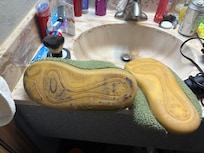 Dirty slipper from floors and clean slipper after cleaning the bottom off.