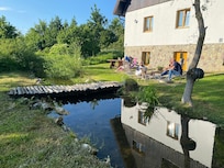 A relaxing seating area next to a small stream is ideal for coffee in the morning or a beer in the afternoon.