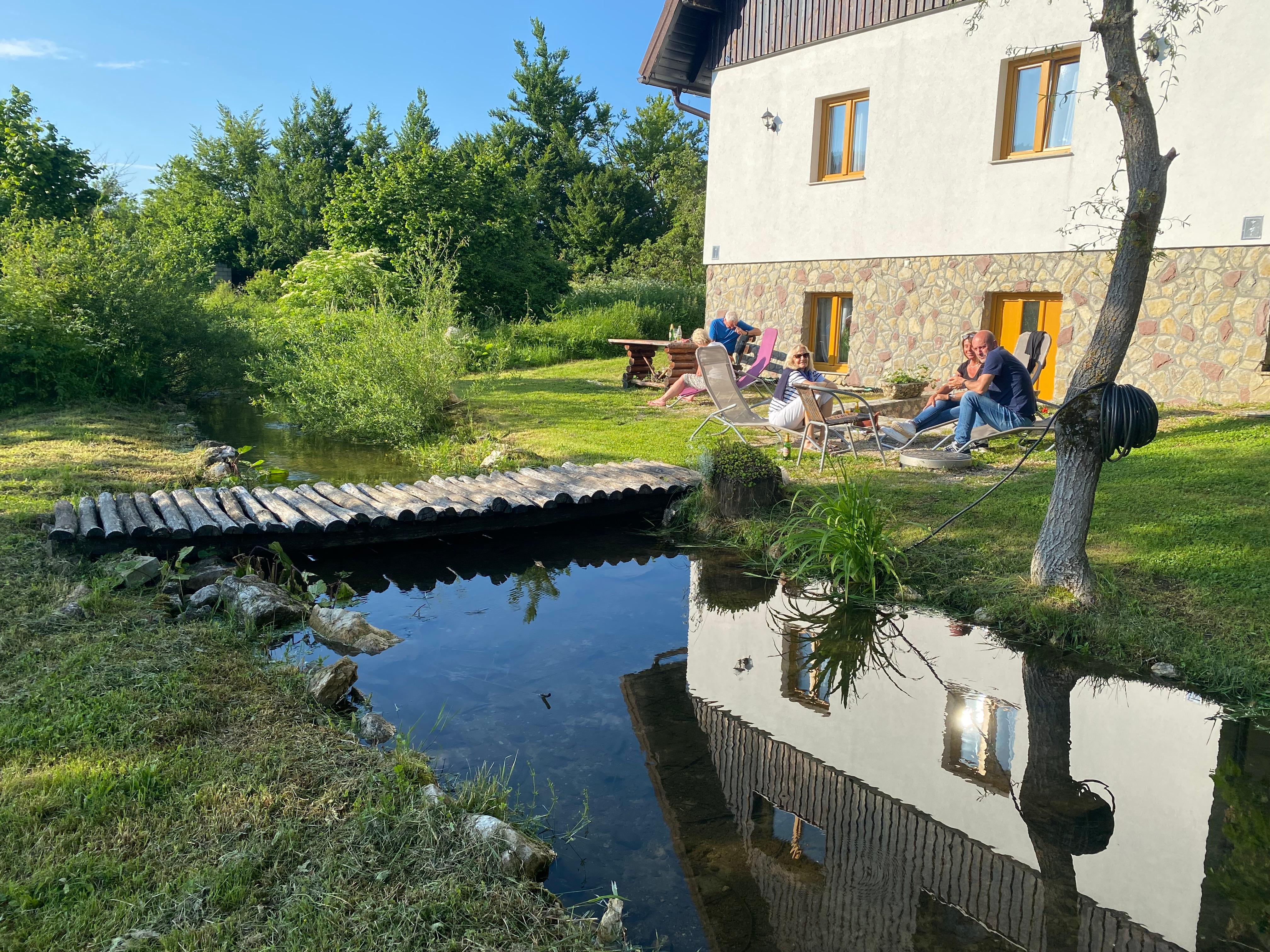 A relaxing seating area next to a small stream is ideal for coffee in the morning or a beer in the afternoon.