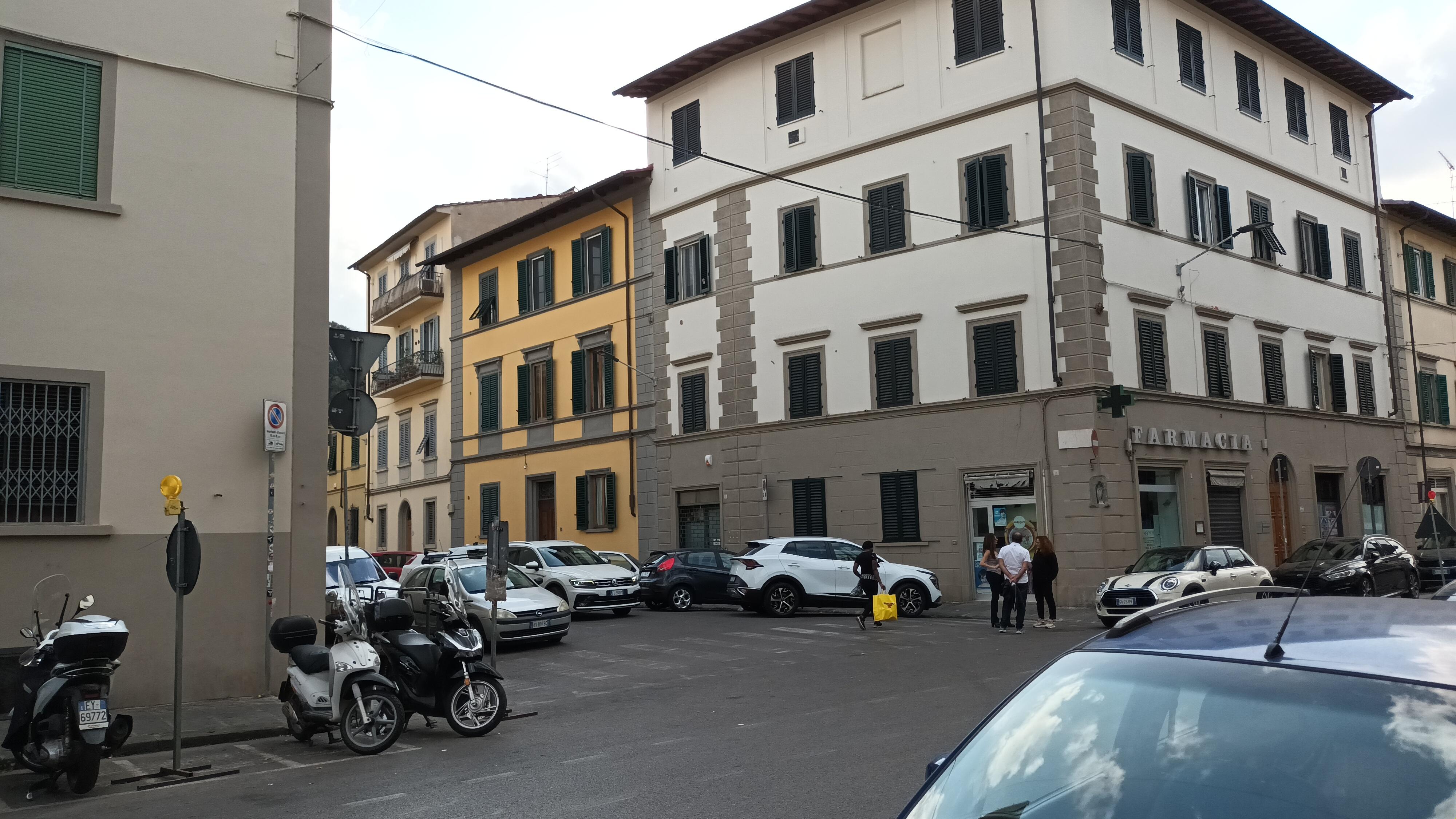 The front door of the apartment is in the yellow building 