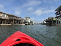 Kayaking through bay in neighborhood