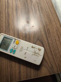 Dirty nightstand and aircon remote