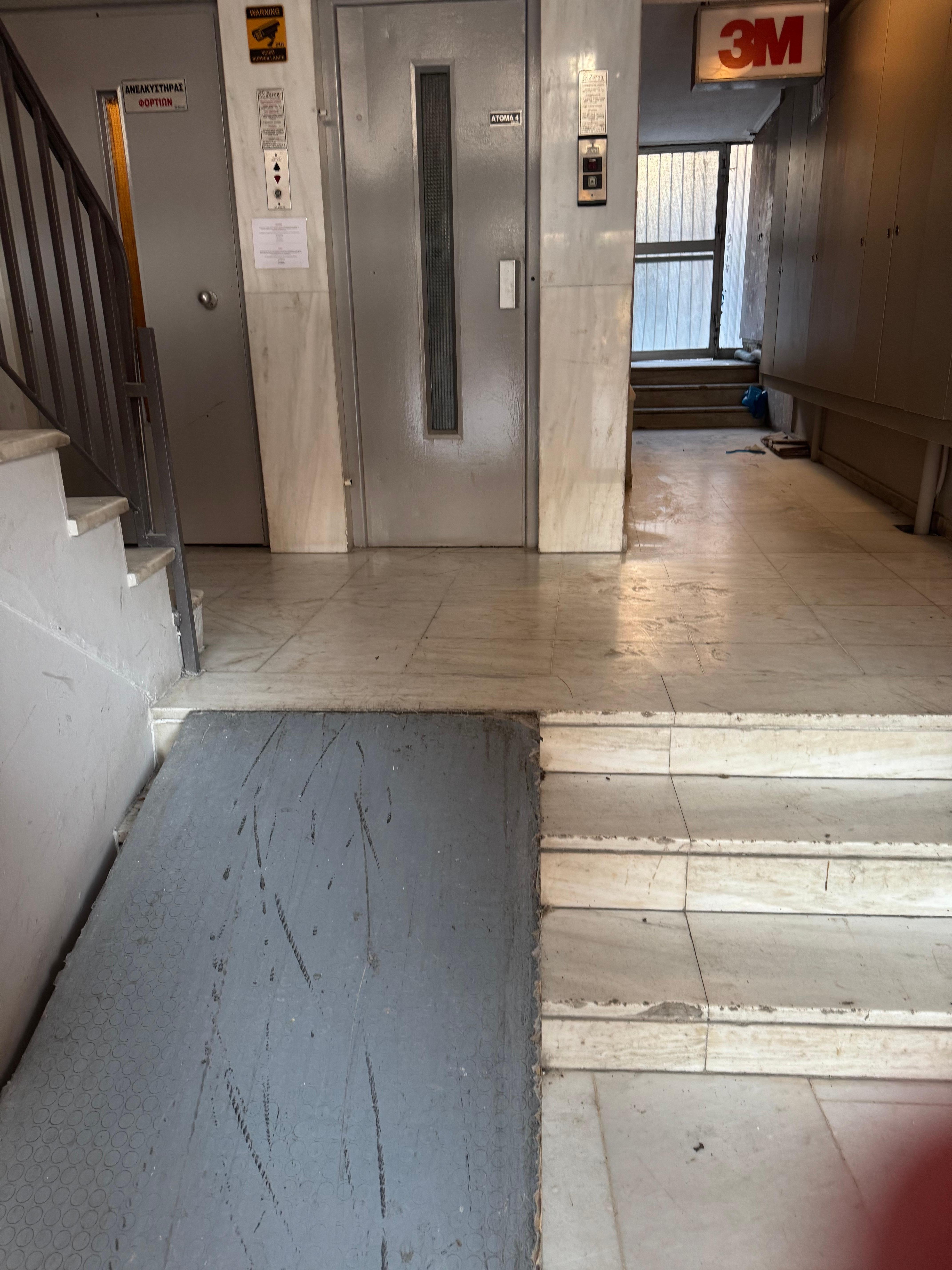 The building lobby and dirty elevator. The hotel is on the fourth floor.