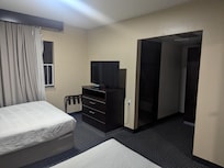 Bedroom leading to bathroom and closet. Notice the bottom drawer is missing a handle.