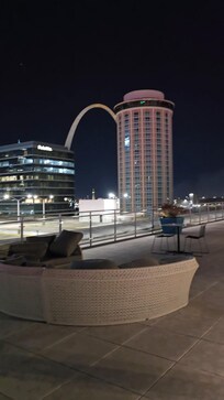 Rooftop at night Arch in the background