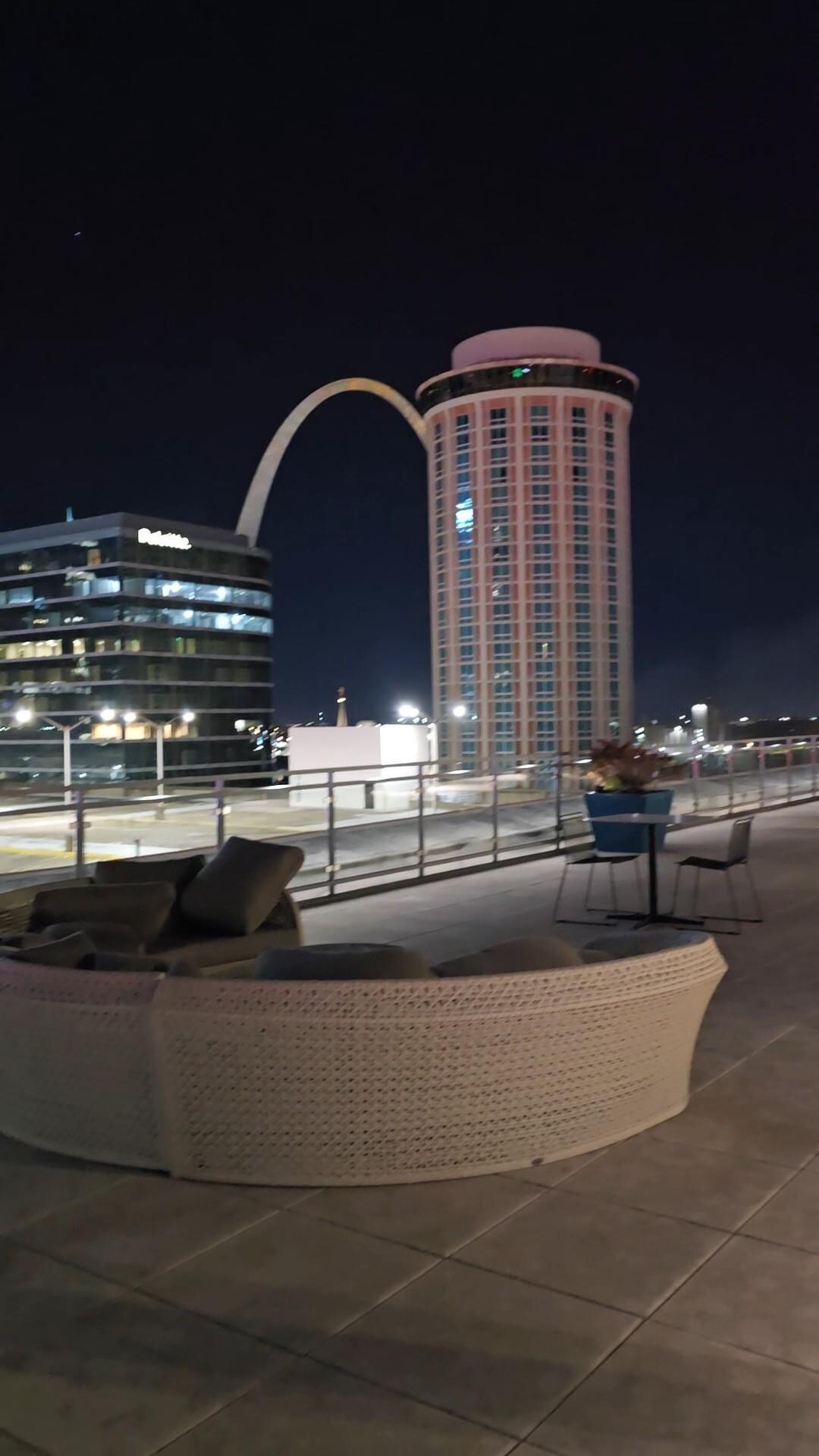 Rooftop at night Arch in the background
