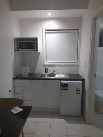 The kitchen with microwave oven, electric kettle, cutlery and fridge. Coffee and tea too.