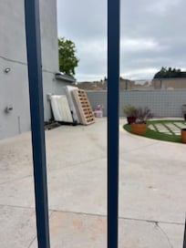 Old mattresses being disposed of in courtyard