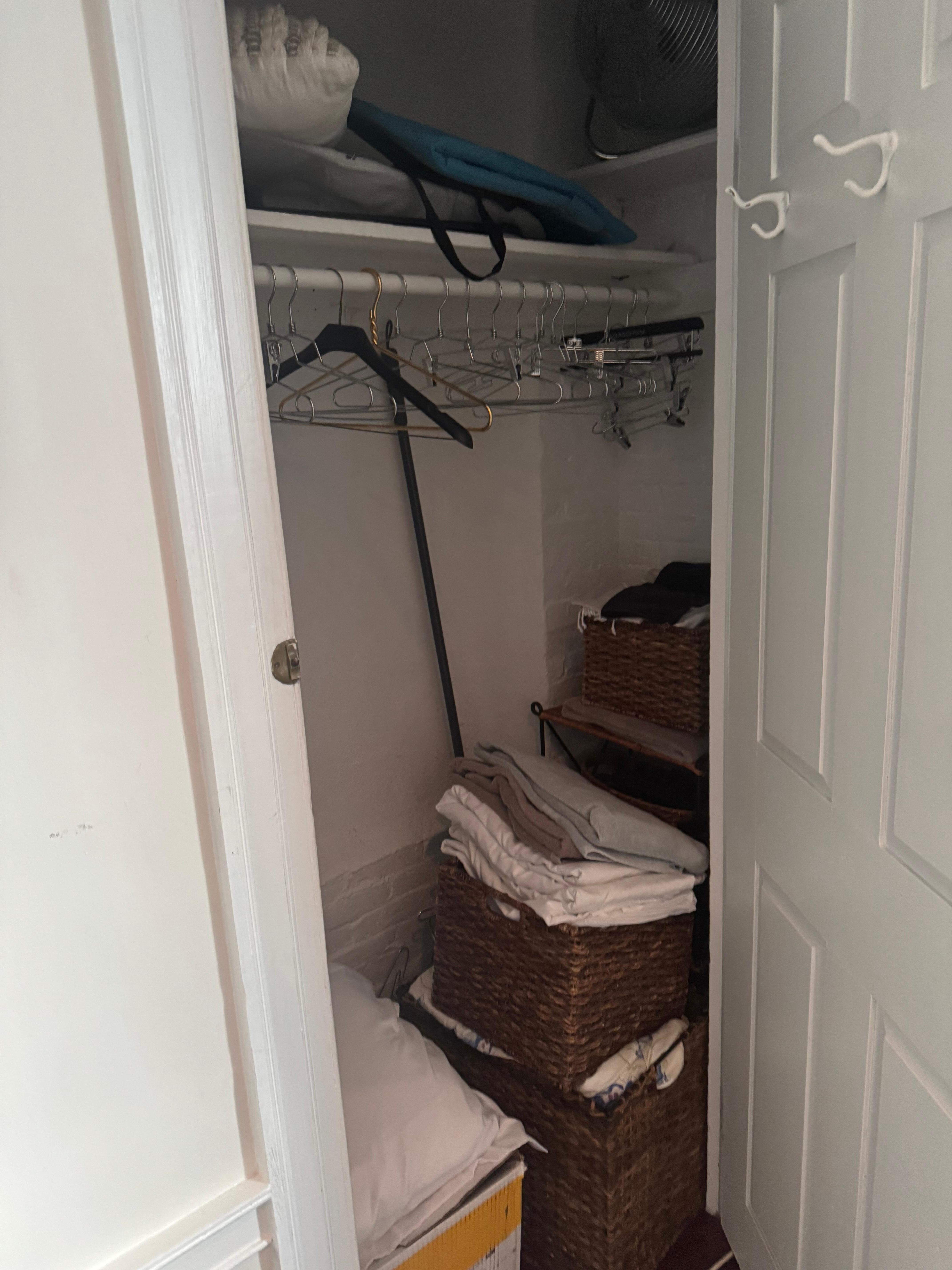 Tiny closet was untidy and jammed with baskets of “stuff.”