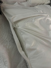 Tattered, tied together pillow sham