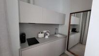 Kitchenette with electric hob, kettle, toaster, coffee maker, microwave, dishwasher and fridge