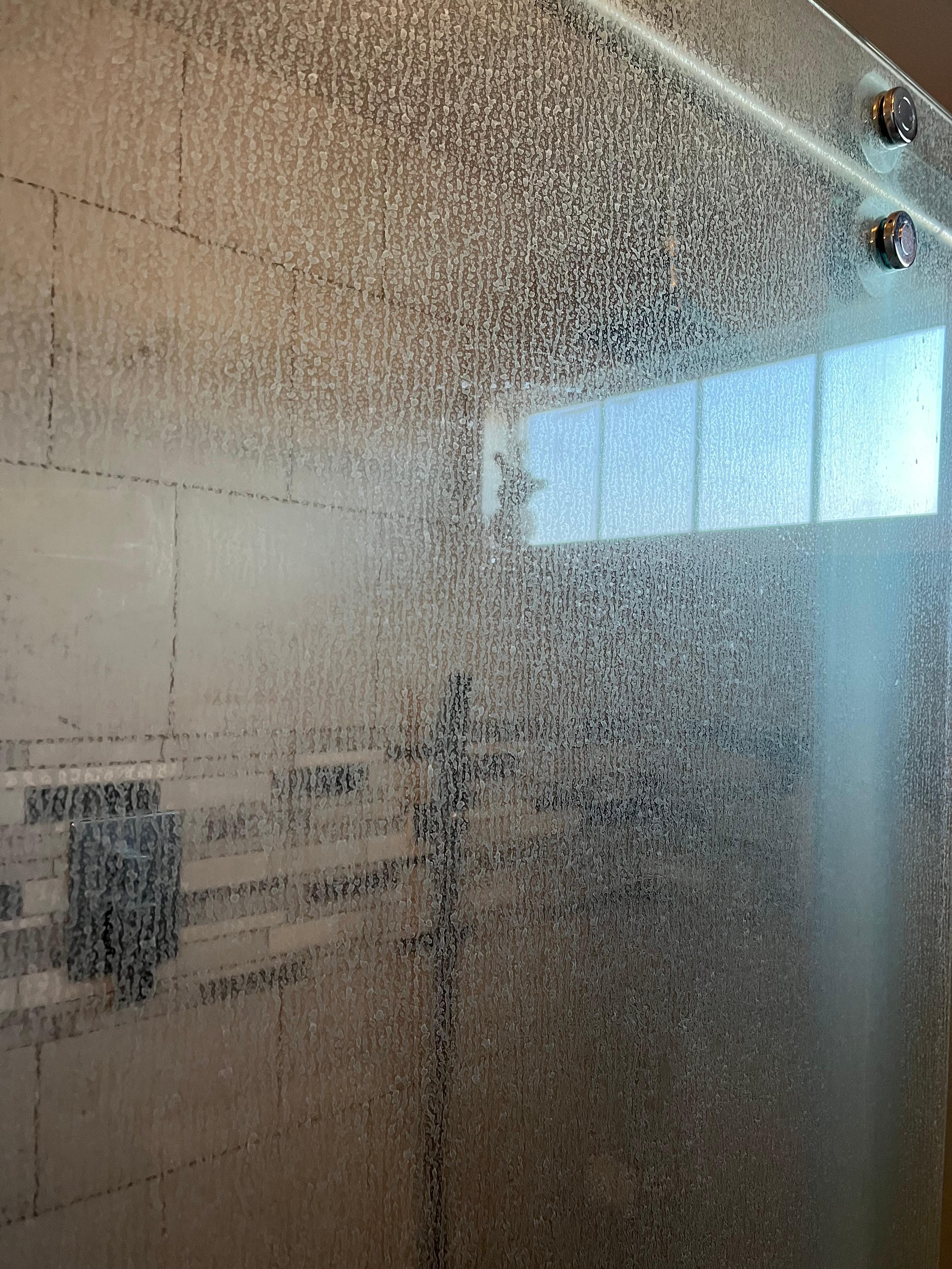 Soap scum solid on both doors inside shower…