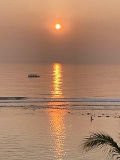 This was the sunrise from my room the day I left.  The boat and fisherman (lower right above the palm) was a bonus)
