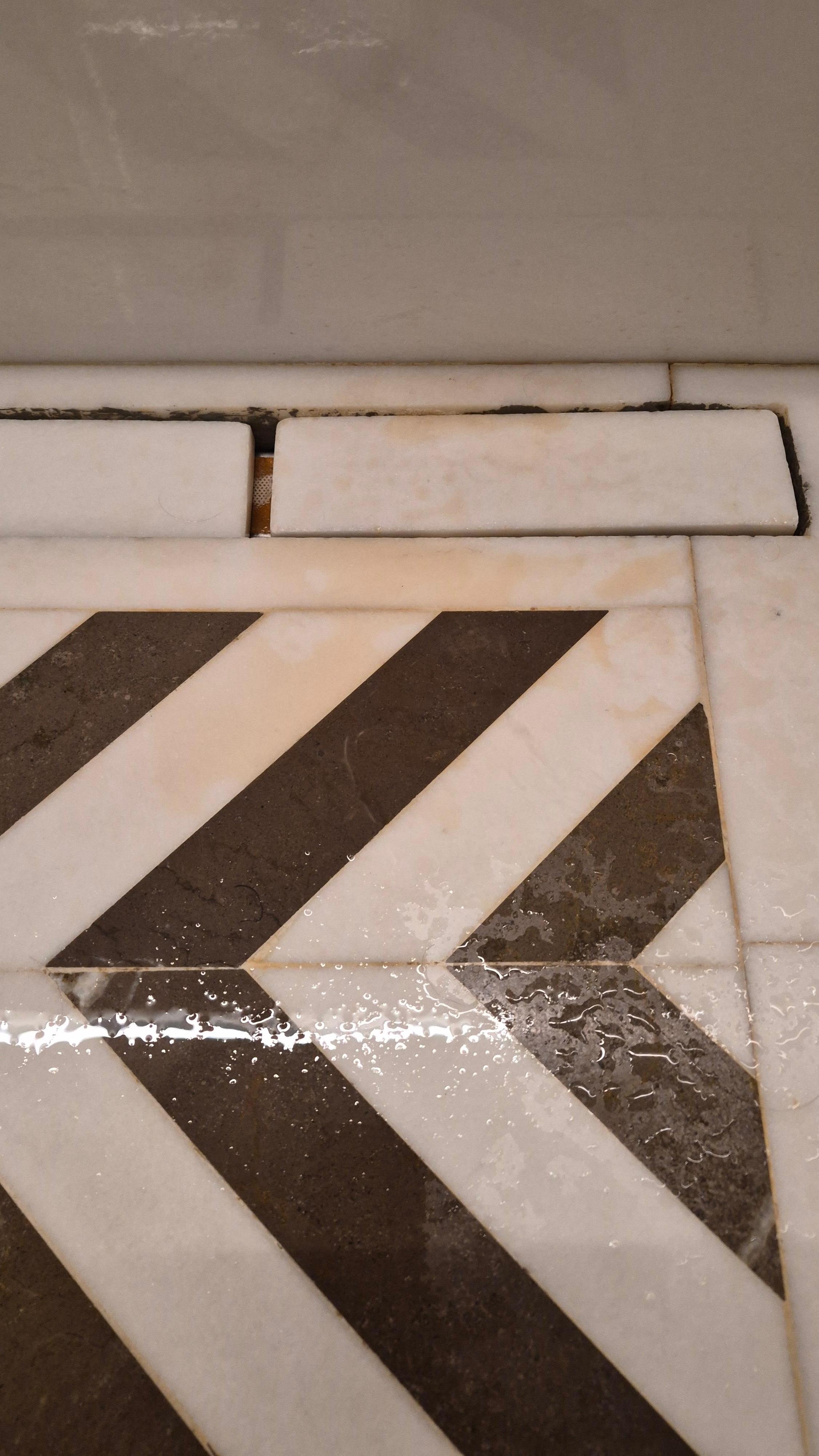 Shower floor stained by brown water