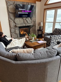 Cuddled up by the fireplace.