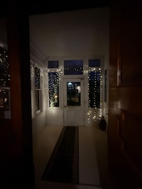Wonderful enclosed porch with cute fairy lights. An open air porch is right in front of this, so you get your choice! The outside isn’t grand, but the inside is impressive if you like homes built in the 1800’s!