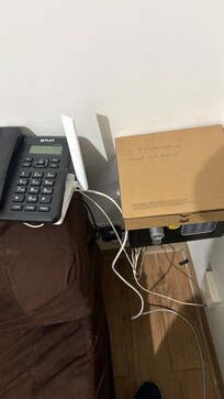 The brown box with the correct access to theWi-Fi password, hidden underneath the phone on top of the modem