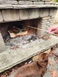 Hotdogs over outside fireplace