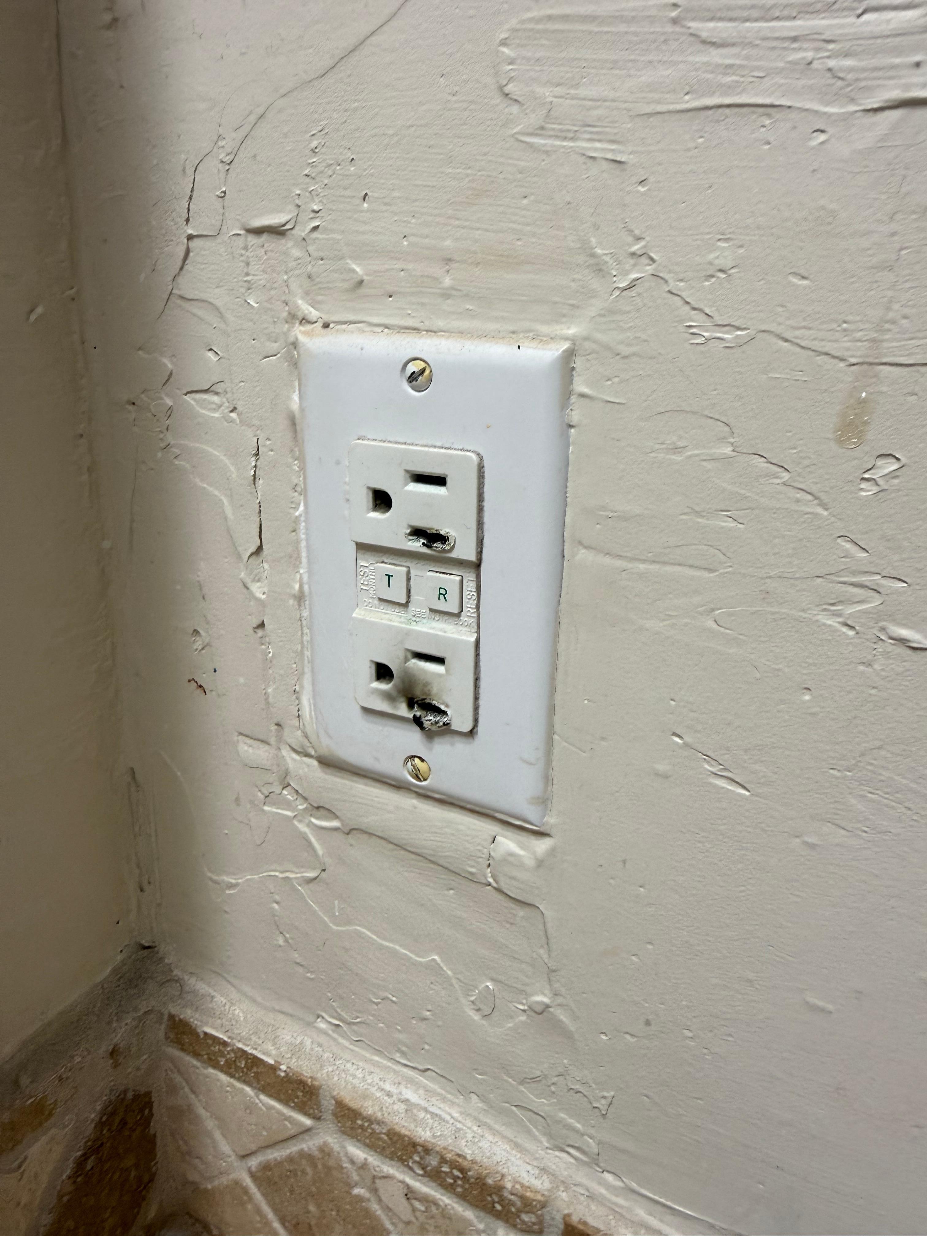 This is the electrical outlet next to one of the bathroom sinks - too frightening to use.  Electrical outlet next to the other sink is not grounded.