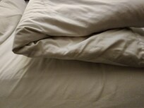 My son stacked 3 pillows and still appeared to be flat against the bed.