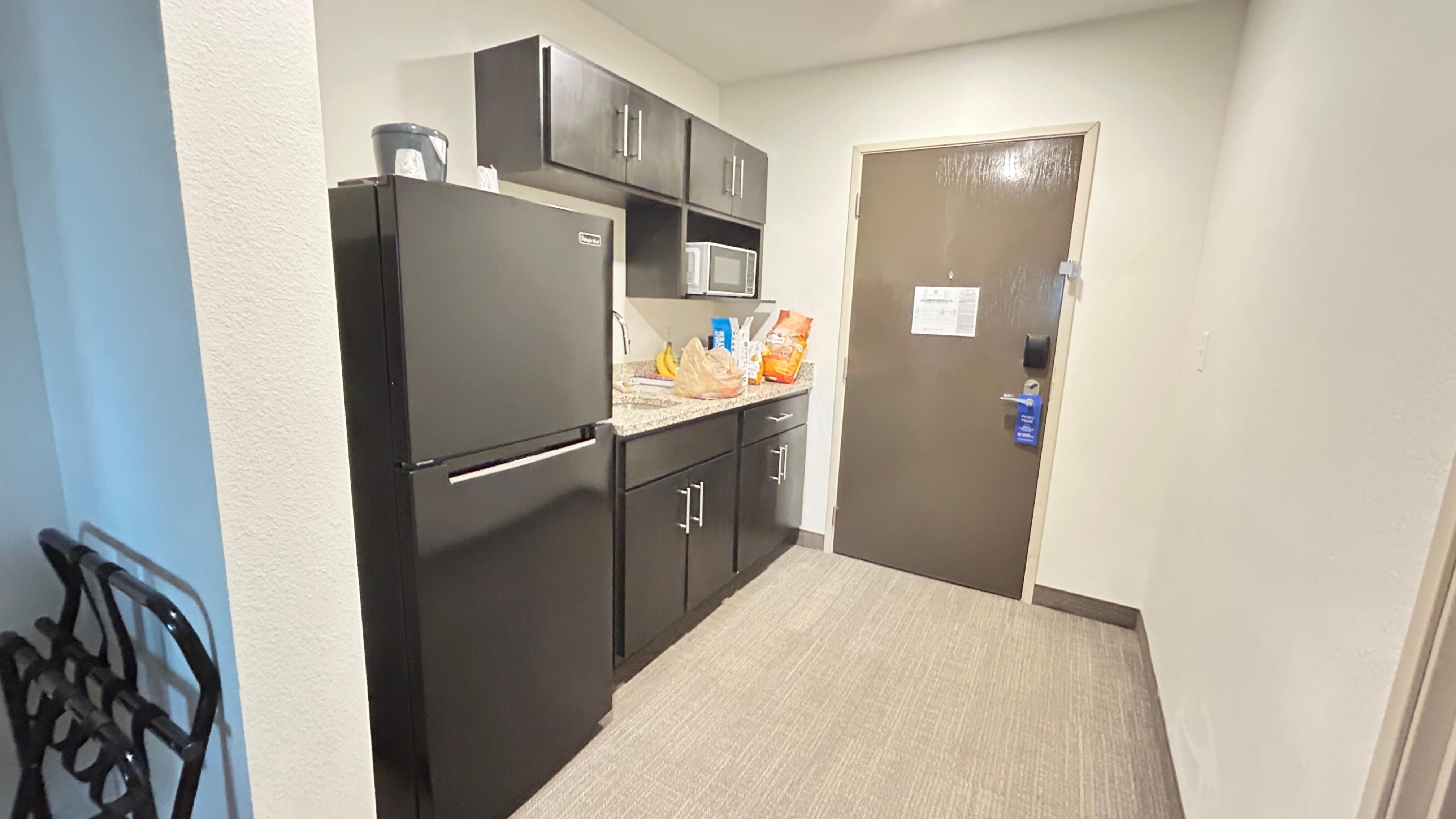 Nice mini kitchen area. Big fridge, microwave, sink, and kitchen supplies. 