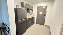 Nice mini kitchen area. Big fridge, microwave, sink, and kitchen supplies.