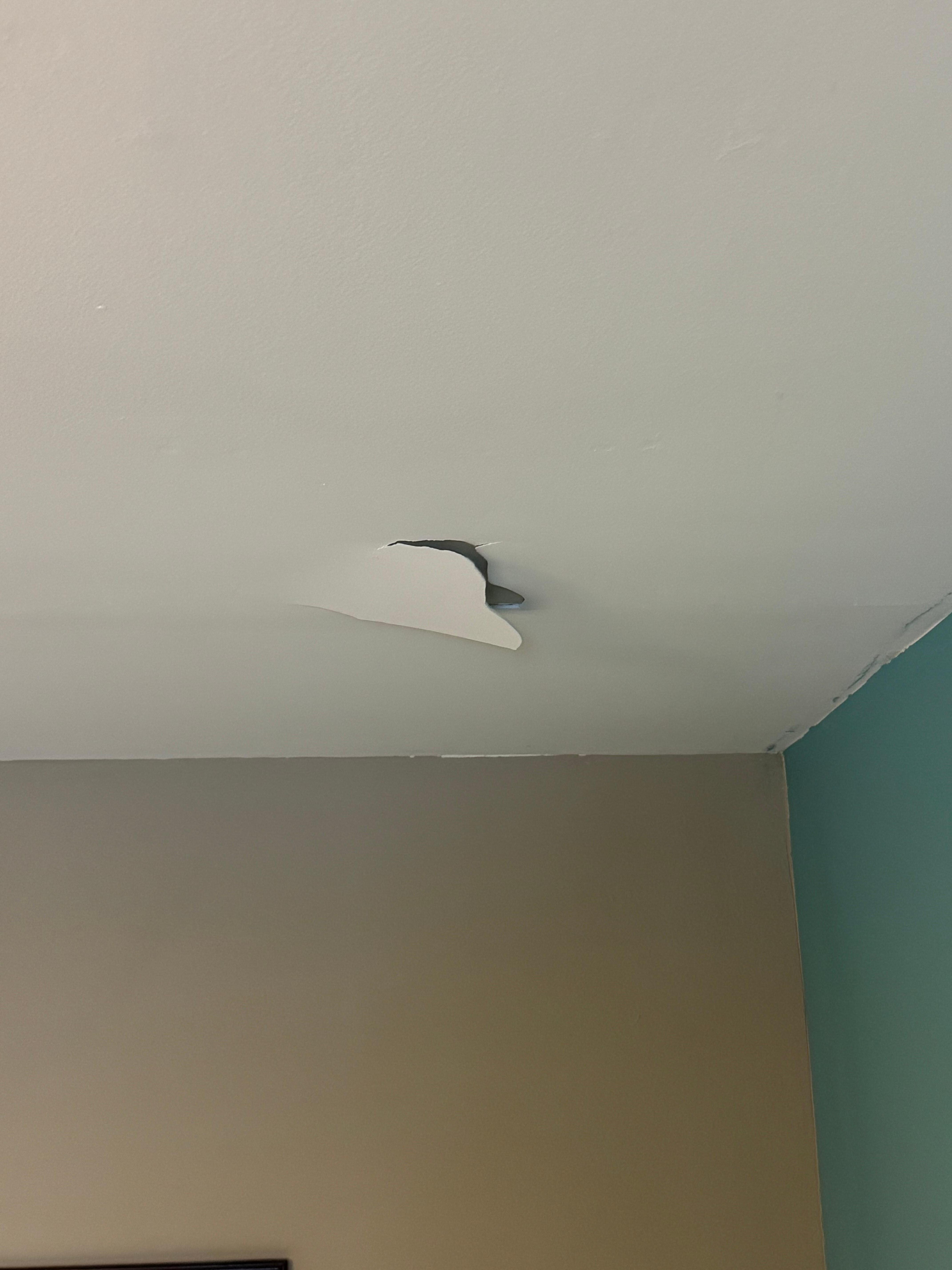 Strips peeling from the ceiling (this is directly over the bed)