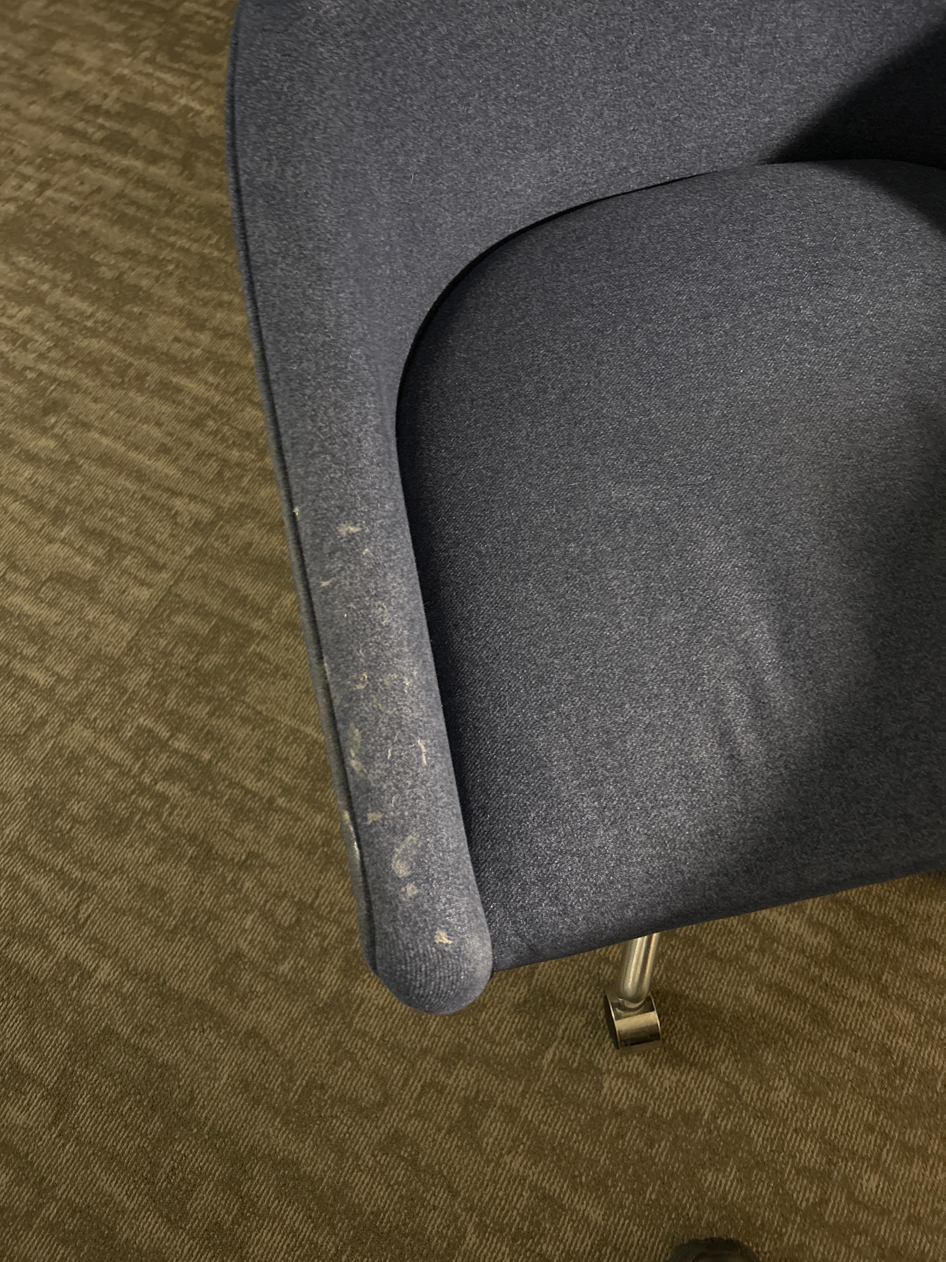 Dirty upholstered chair in the room.