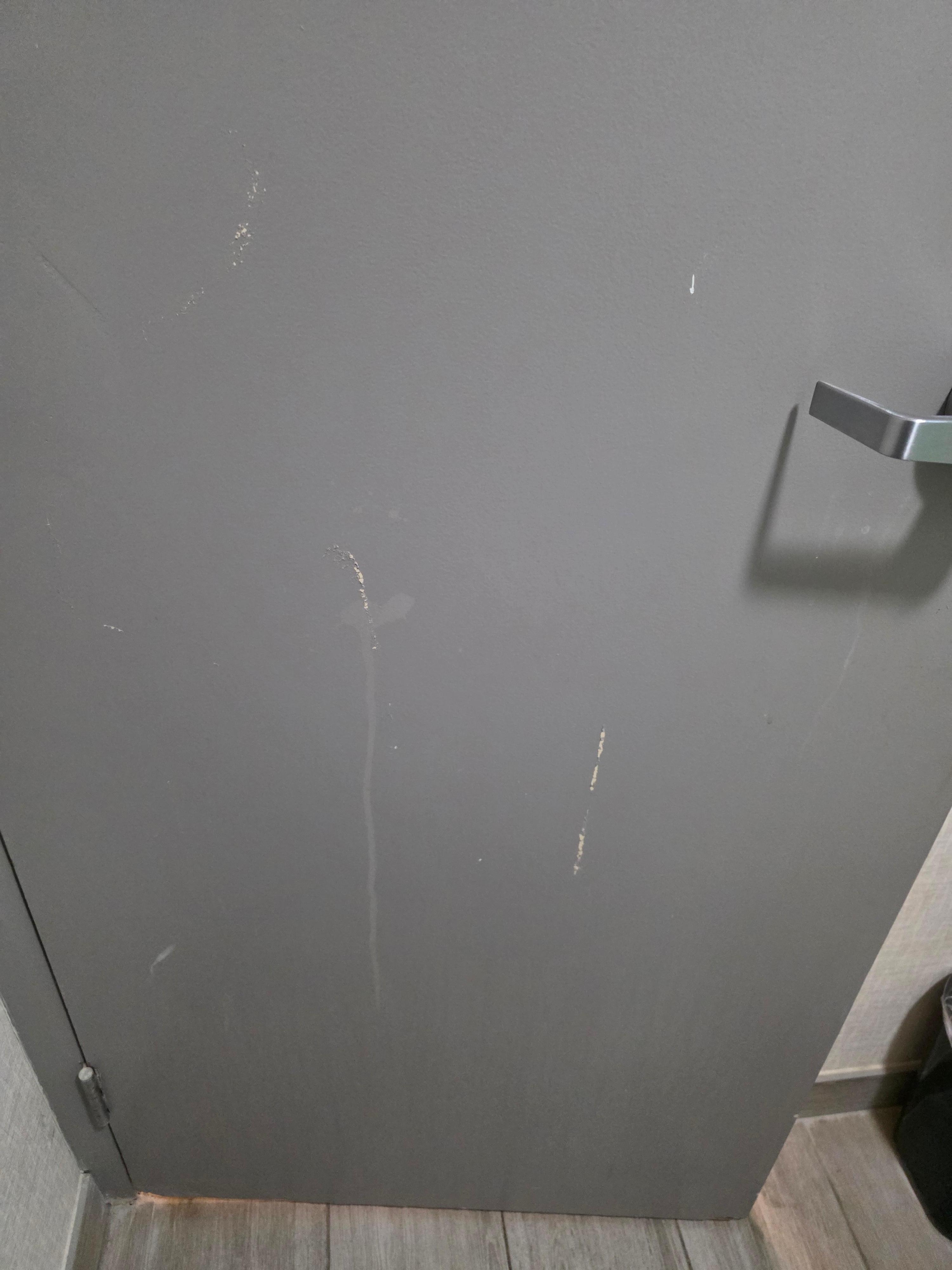 Onside of bathroom door with gouging