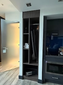 Closet area with iron and safe.