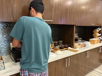 Grandson cooking his own waffles. Very proud of him, he is autistic.