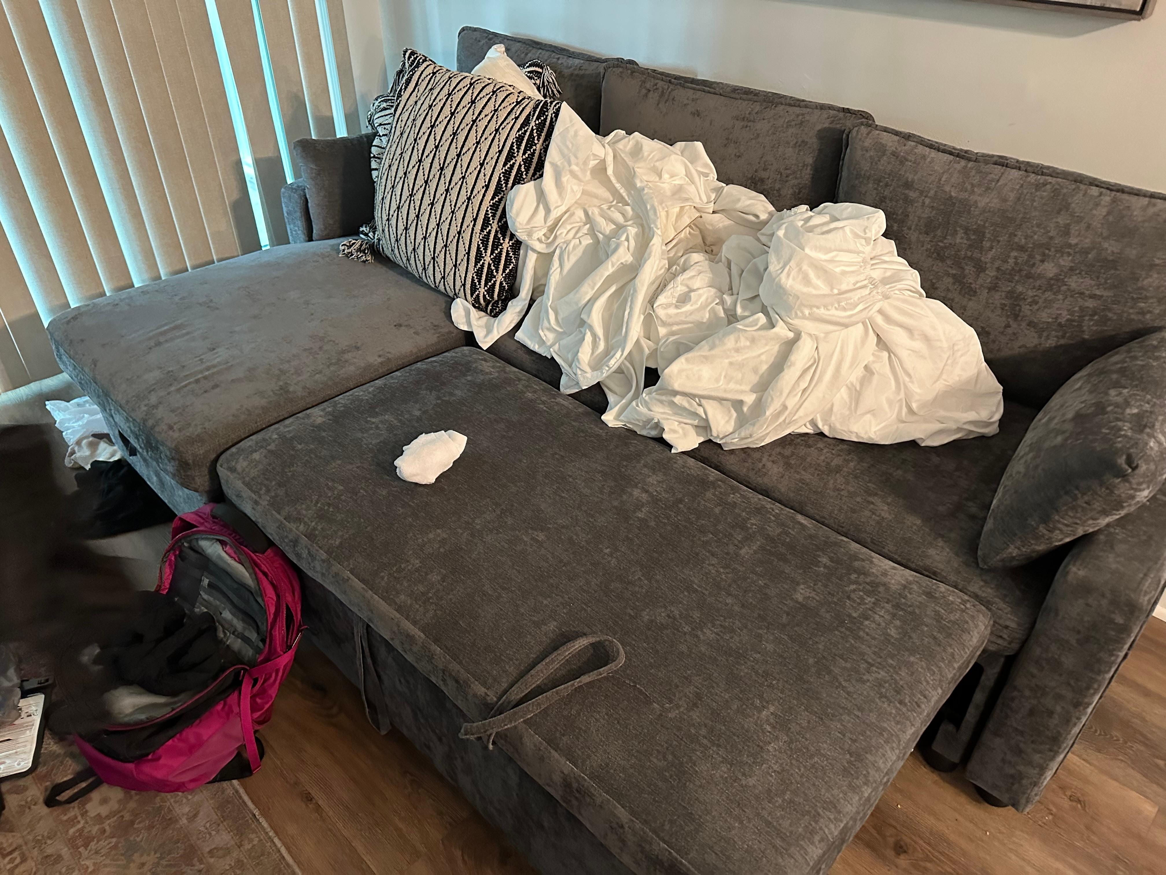 This hard couch in the living room is NOT a queen bed in a third BEDROOM as advertised.