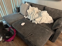 This hard couch in the living room is NOT a queen bed in a third BEDROOM as advertised.