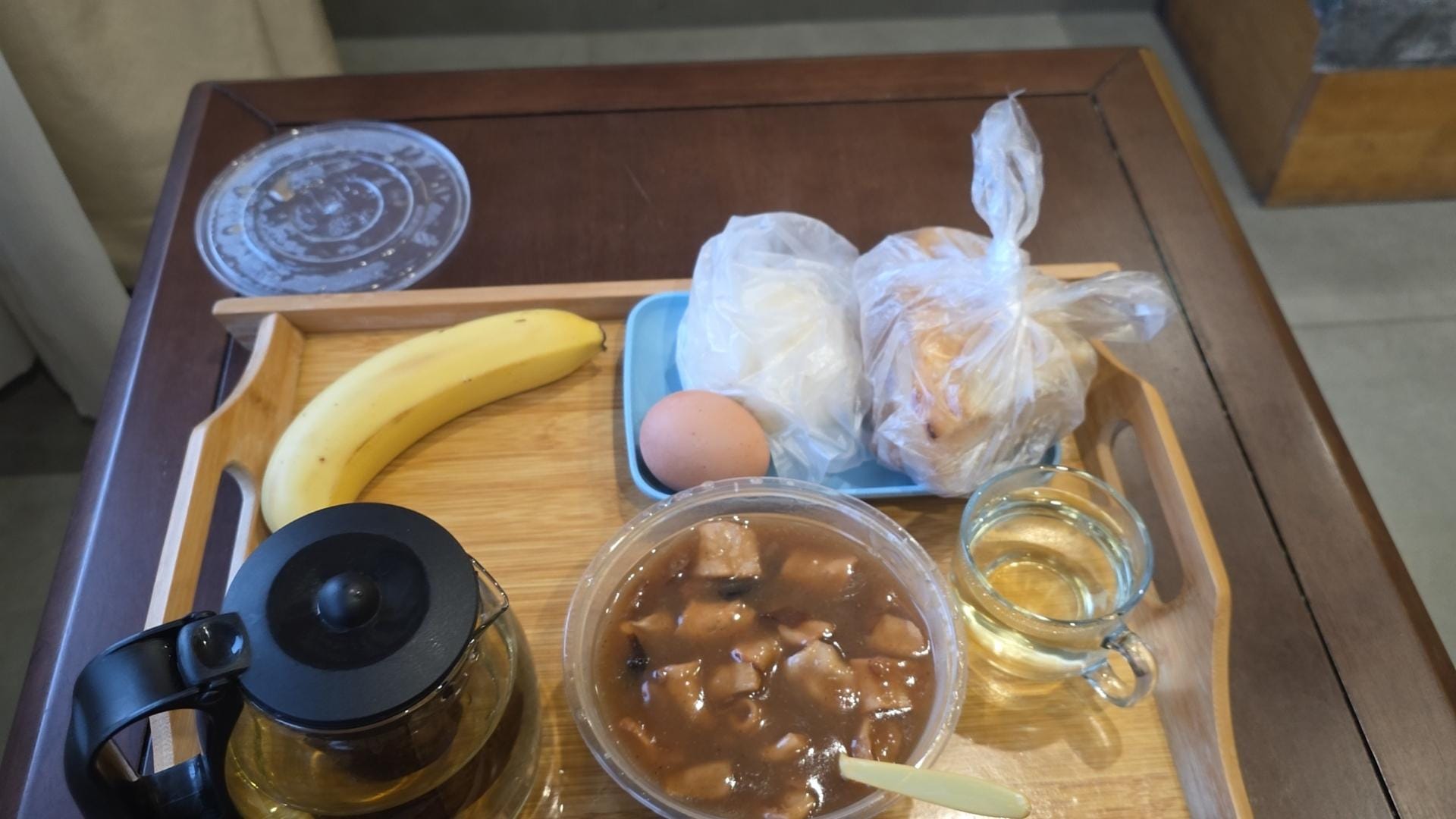 Breakfeast. Beef dumpling, boiled egg, pancake, banana, i forgot, and tea.